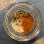 rub seasonings in ball jar on piece of slate and burlap mat.