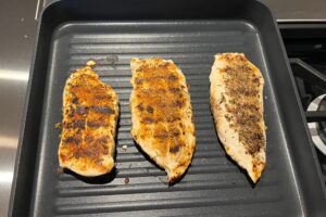 rubbed grilled chicken on grill pan.