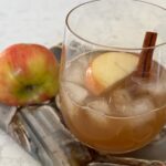 Apple Cider Mule with cinnamon stick and apple on agate board.