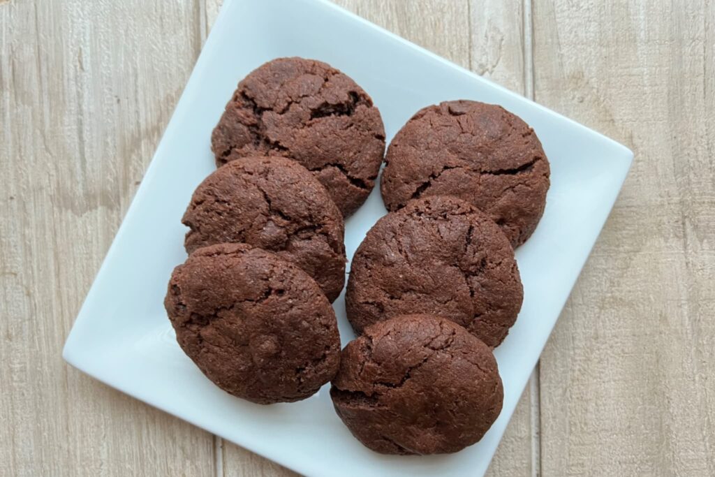 chocolate chocolate chip cookies on white plate.
