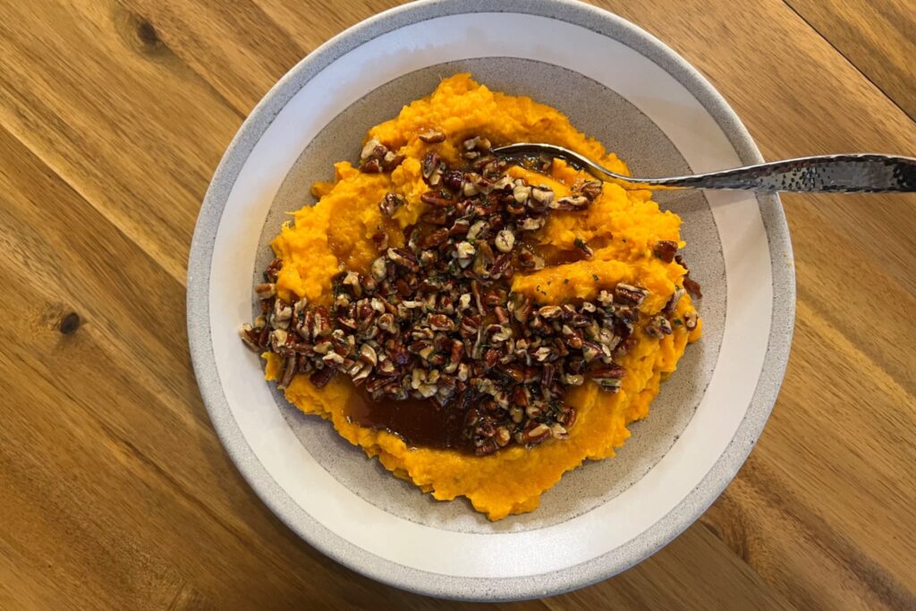 Mashed Sweet Potatoes with Maple Pecan and Rosemary Topping in Grey Bowl.