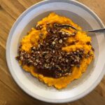 Mashed Sweet Potatoes with Maple Pecan and Rosemary Topping in Grey Bowl.