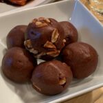 brownie bites with nuts in a white bowl.