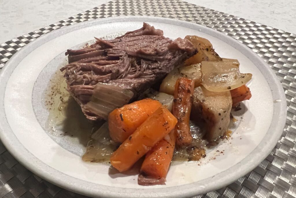 Beef Pot Roast with carrots and potatoes on plate.