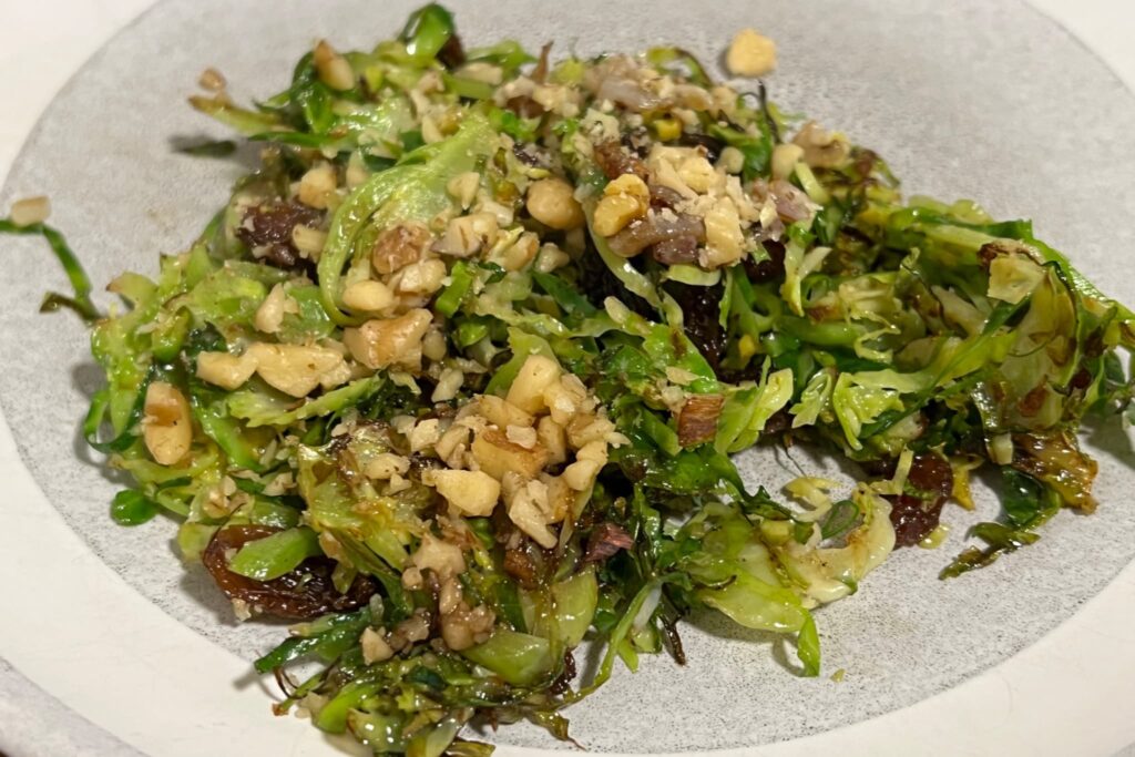 Shaved Brussel Sprouts with shallots raisins and walnuts.
