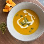 pureed butternut squash and apple soup with cashew cream and roasted pumpkin seeds.