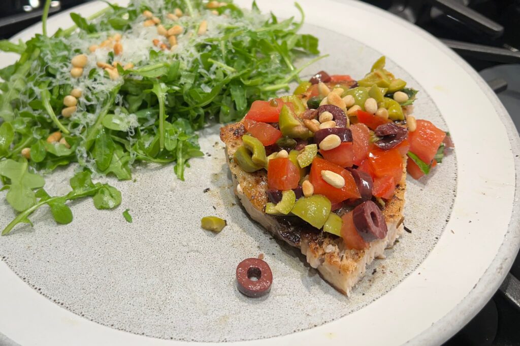 swordfish with olive and tomato salsa with arugula salad.