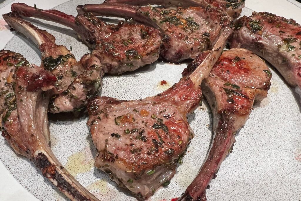 Herb marinated lamb chops on gray plate.