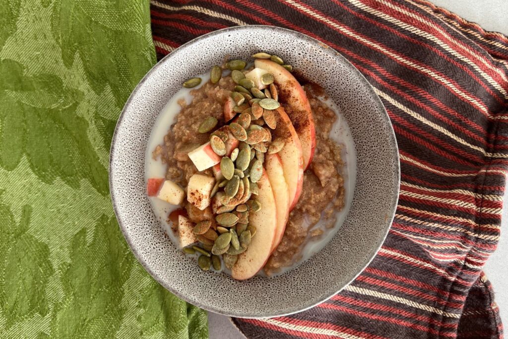 Apple and Millet Porridge with Pumpkin Seeds in bowl.
