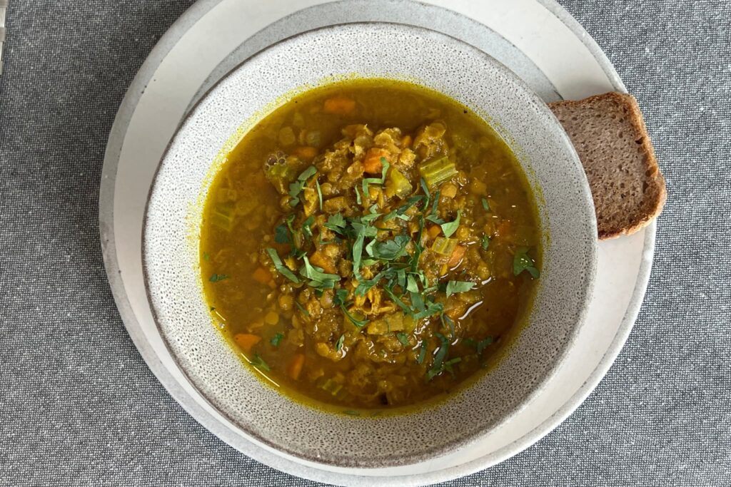 lentil soup in gray bowl.